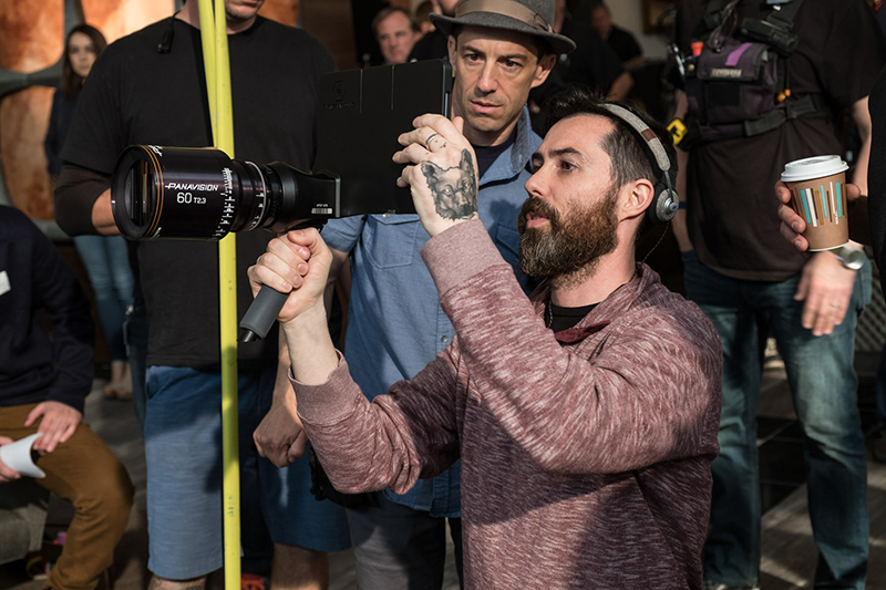 A film director holding a camera on set