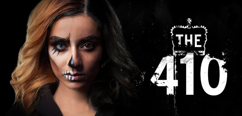 A woman with her face half-painted and "The 410" on right side against a black background.