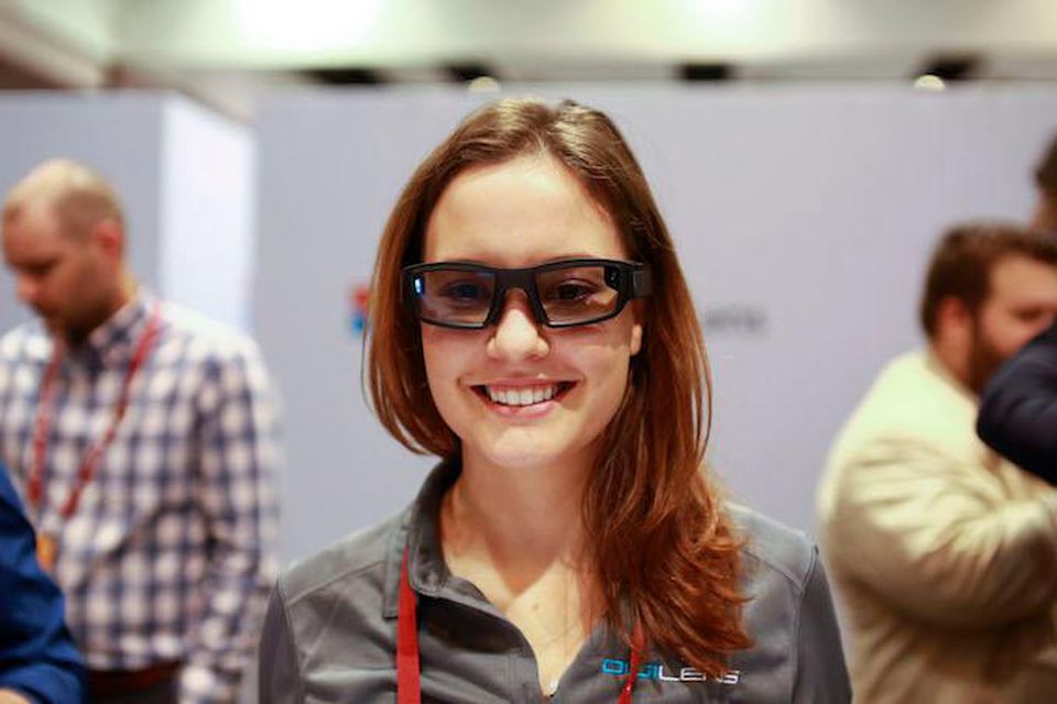 A headshot of a woman wearing smart glasses.